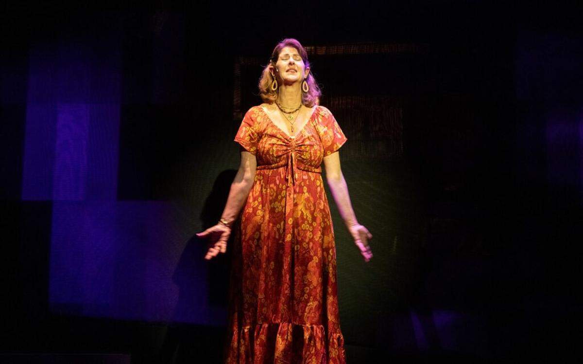 Actress Patti Gardner as Alice in costume designer Brooke Vacca’s breezy orange dress.