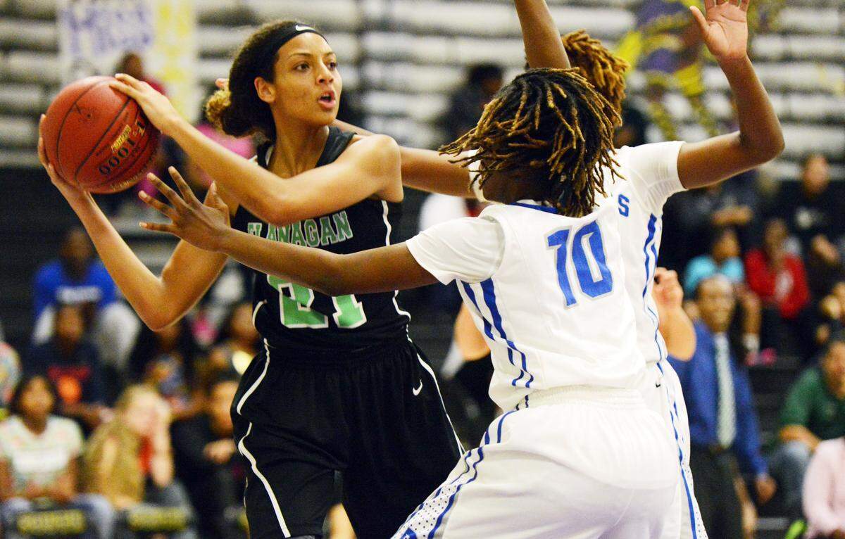 Mikiah Harrigan of Flanagan looks to pass the ball as the Dillard defense closes in. BCAA girls Big 8 Championship. Plantation, FL. 1-24-15. Jim Rassol, Sun Sentinel.