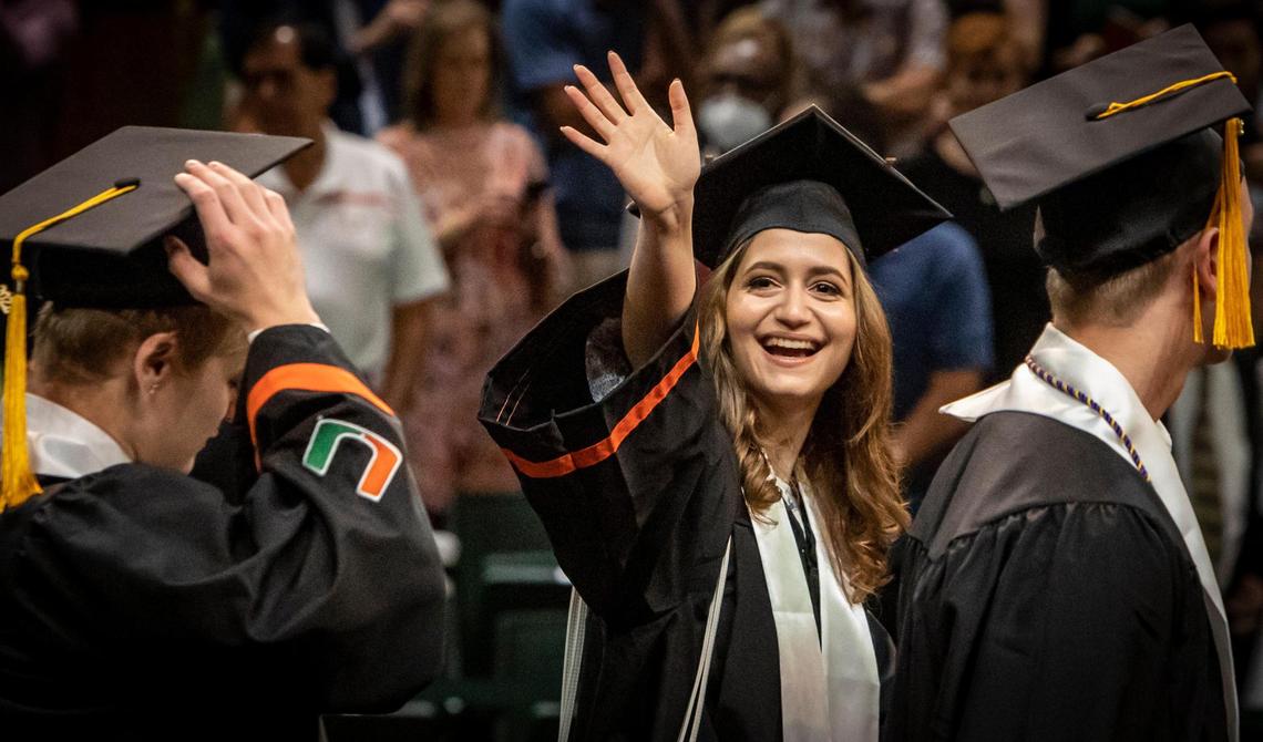 Maria Laura Garcia waves to her family as she and other graduates file into the University of Miami commencement ceremony in Coral Gables on May 13, 2022.