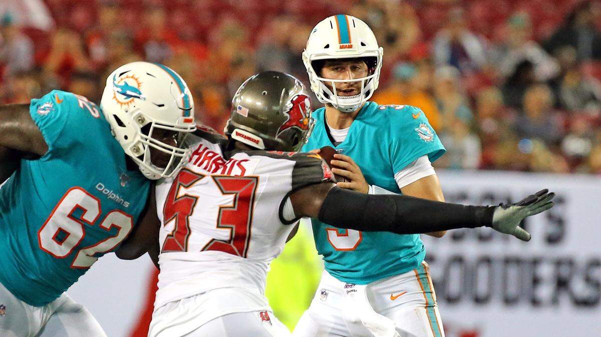 Miami Dolphins guard Shaq Calhoun (62) tries to block Tampa Bay Bucs Demone Harris (53) as he rushes Fins quarterback Josh Rosen (3) in the second quarter at Raymond James Stadium in Tampa, Florida, Friday, August, 16, 2019.