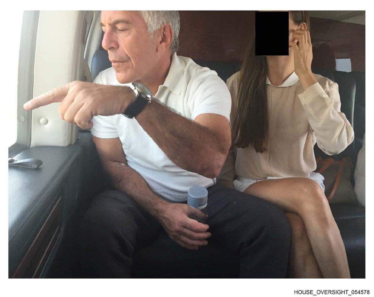 Jeffrey Epstein sits on a plane next to a woman whose face is blacked out in this undated photo released by the late financier’s estate to the House Oversight Committee, which made additional documents public on Dec. 18, 2025.