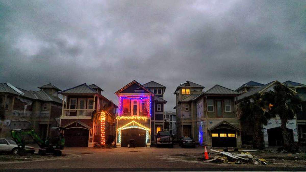 Christmas lights illuminate a home on U.S. 98 in Mexico Beach, most of which remains in a suspended state of destruction two months after Hurricane Michael made landfall on Oct. 10.