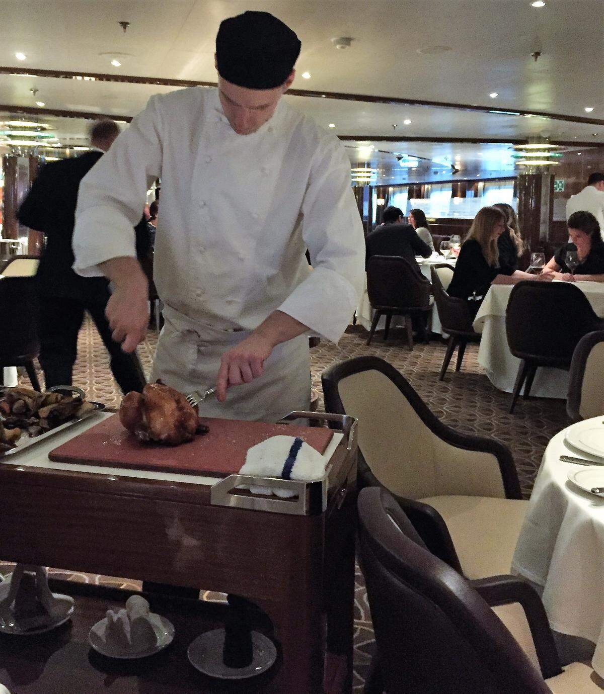 Roast chicken, carved tableside for two, is among the favorite dishes at the Thomas Keller Grill on Seabourn Ovation and other ships of Seabourn Cruises.