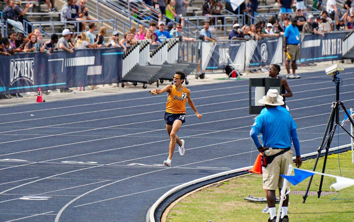 Belen Jesuit’s Marcelo Mantecon crosses the finish line on Saturday after winning his race and helping the Wolverines secure their first state team track and field title since 2007.