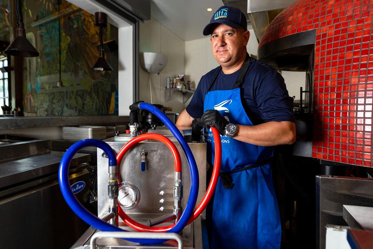 Filta service technician Richard Erin stands next to the mobile filtration unit at Cerveceria La Tropical in Wynwood, on Wednesday, May 24, 2023. The basic function of the service technicians like Erin is to provide mobile fryer management services to commercial kitchen customers.