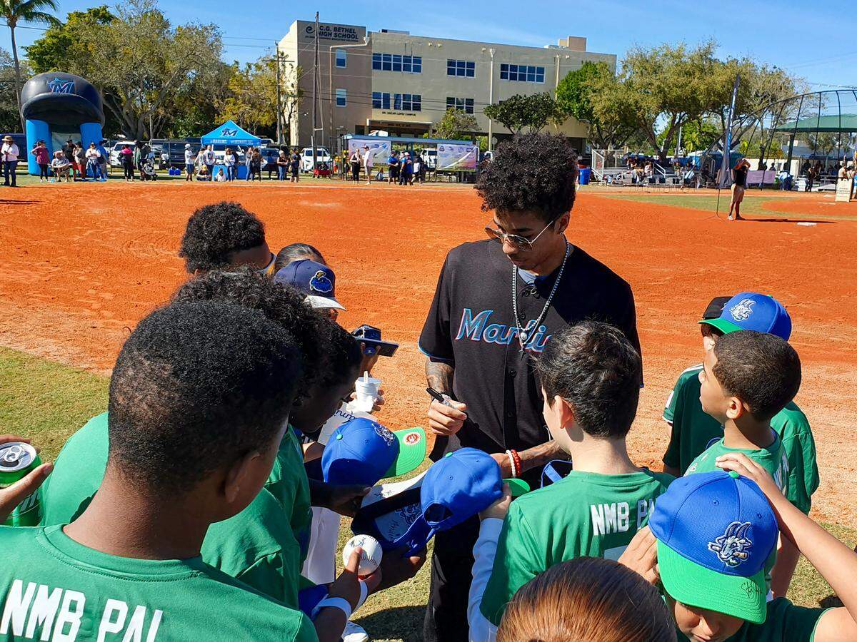 Miami Marlins pitcher Sterling Sharp signs autographs signs autographs for members of North Miami Beach Little League at Allen Park on Sunday, Jan. 26, 2020.