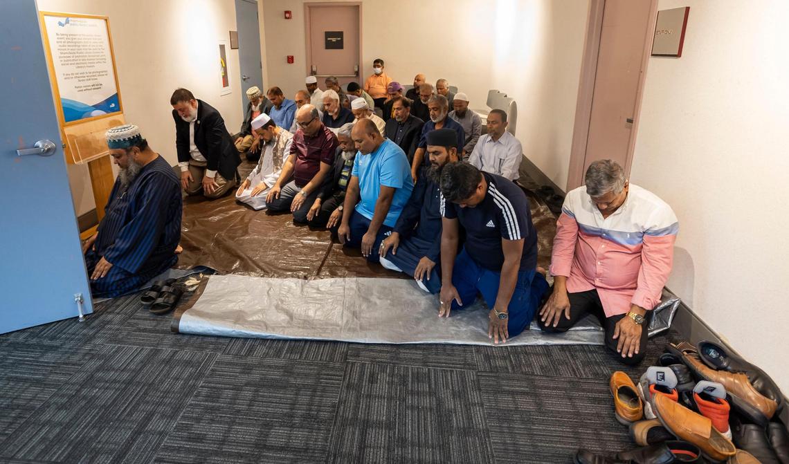 People pray outside of a public zoning meeting at the South Dade Regional Library. The Muslim community is requesting permission to build a new cemetery in Southwest Dade. There is only one other solely Muslim cemetery in South Florida.