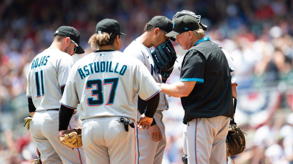 Miami Marlins pitching coach Mel Stottlemyre, front right, visits the mound and speaks with starting pitcher Elieser Hernandez, third from left, in the first inning of a baseball game against the Atlanta Braves, Sunday, May 29, 2022, in Atlanta. (AP Photo/Hakim Wright Sr.)