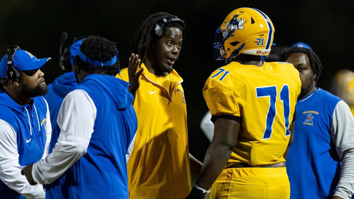Miami Northwestern Bulls head coach Teddy Bridgewater talks with offensive tackle Anthony Bell (71) in the first half of their football game against the Coconut Creek Cougars at Coconut Creek High School on Thursday, Aug. 22, 2024.