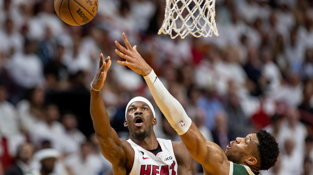 Miami Heat forward Jimmy Butler scores while Milwaukee Bucks forward Giannis Antetokounmpo defends during the first quarter of Game 4 in the first-round NBA playoff series at the Kaseya Center on Monday, April 24, 2023, in downtown Miami.