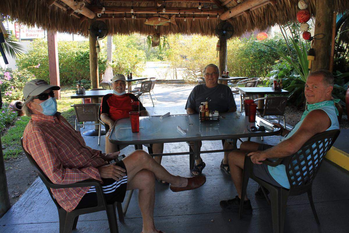 Tom Pizzuti, Lou Keith, Steve Johnson and Don Reese gather at an outside table at Keys Bite Restaurant in Key Largo.