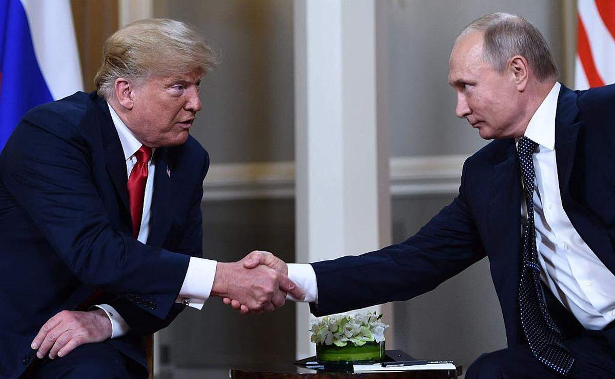 TOPSHOT - Russian President Vladimir Putin (R) and US President Donald Trump shake hands before a meeting in Helsinki, on July 16, 2018. (Photo by Brendan Smialowski / AFP) (Photo by BRENDAN SMIALOWSKI/AFP via Getty Images)