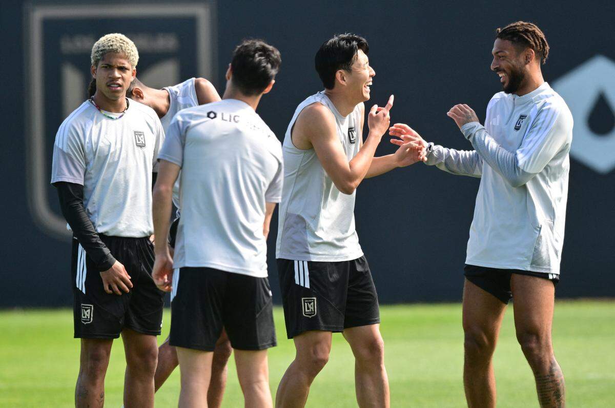 Los Angeles Football Club's South Korean player Son Heung-Min (2R) speaks with teammate Los Angeles Football Club's French forward Denis Bouanga (R) during a training session at The Liquid I.V. Performance Center on the campus of Cal State LA in Los Angeles on February 20, 2026. (Photo by Frederic J. Brown / AFP via Getty Images)