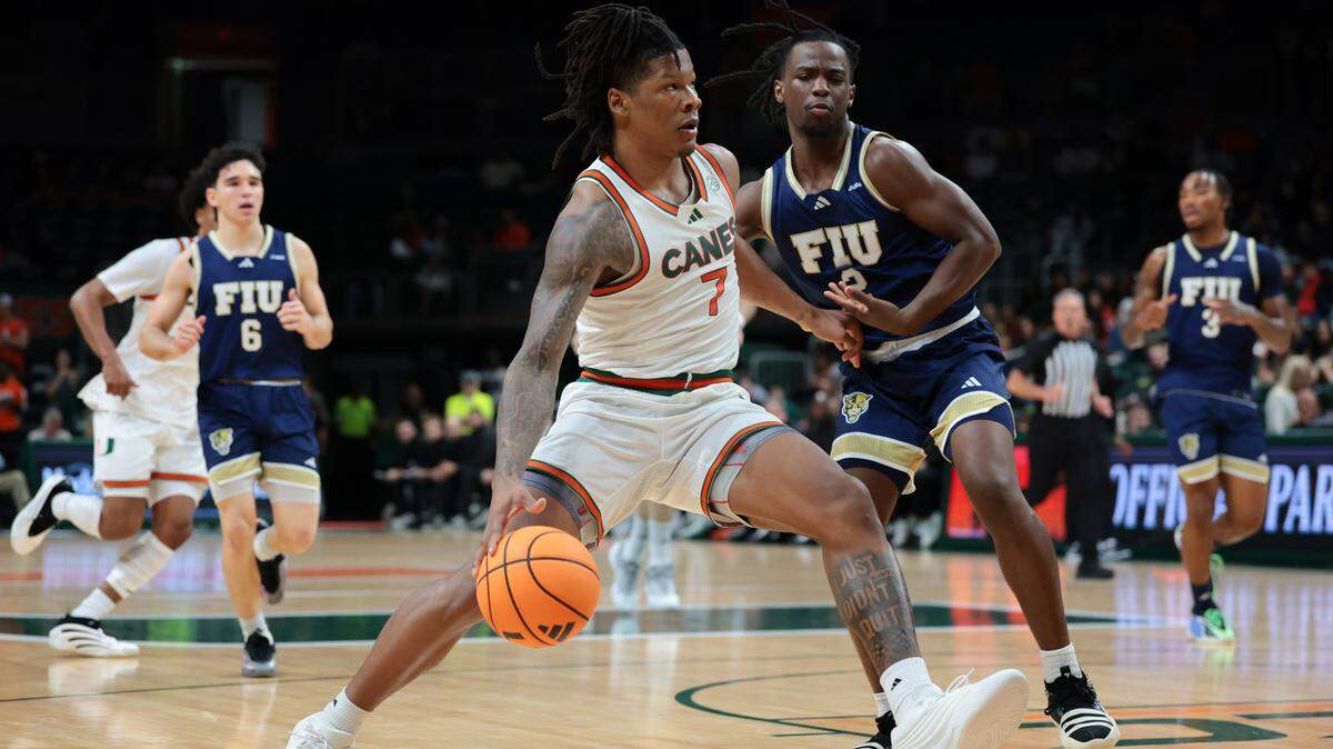 Miami Hurricanes forward Shelton Henderson (7) drives to the basket against FIU Panthers guard Zawdie Jackson (2) during the first half at Watsco Center on Tuesday, Dec. 16, in Coral Gables, Fla.