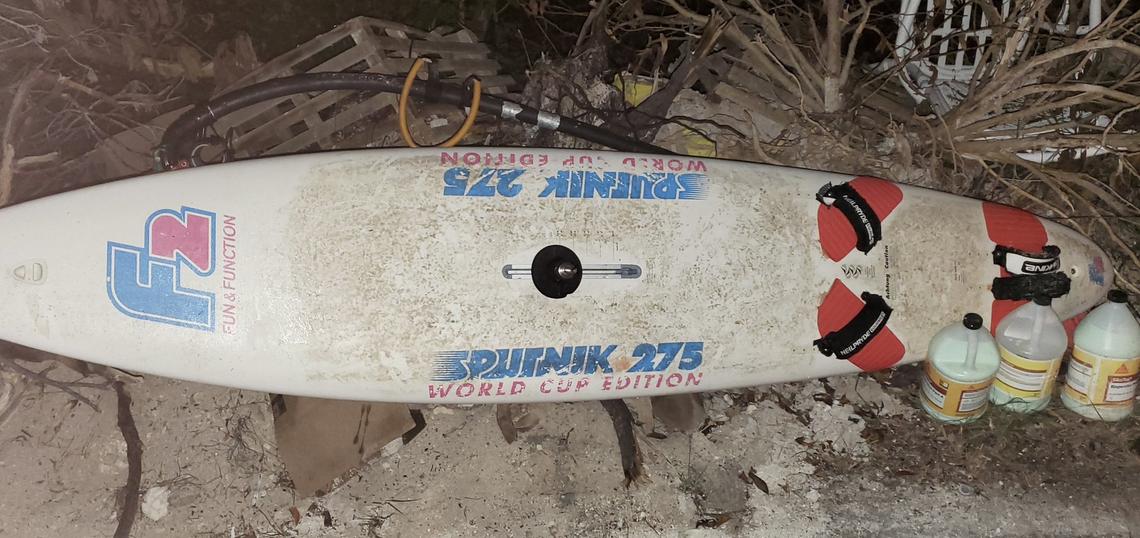 A wind surfboard lies on the ground in the Middle Florida Keys Wednesday, Oct. 12, 2022. It is one of two wind surfboards on which migrants arrived in the Keys from Cuba, according to the Border Patrol.