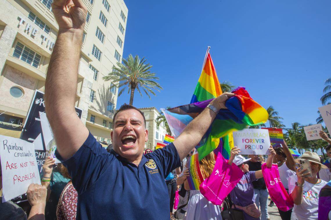 Miami Beach City Commissioner Alex Fernandez waves a flag alongside demonstrators carrying rainbow flags and signs reading ‘Miami Beach Forever Proud’ and ‘Won’t Be Erased’ during the Forever Proud March on Ocean Drive in Miami Beach, Fla., Sunday, Aug. 31, 2025, held after state officials ordered the removal of the city’s LGBTQ Pride crosswalk.