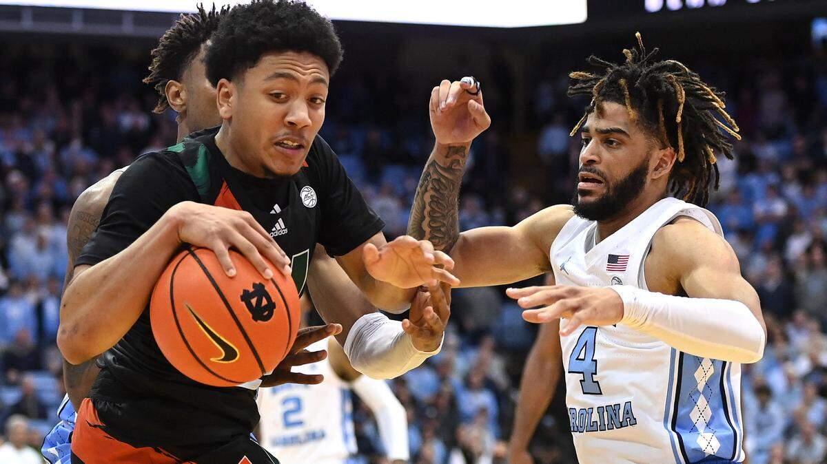 Feb 13, 2023; Chapel Hill, North Carolina, USA; Miami (Fl) Hurricanes guard Nijel Pack (24) with the ball as North Carolina Tar Heels forward Leaky Black (1) and guard R.J. Davis (4) pressure. Pack had 23 points and will be counted on when the teams play on Feb. 10, 2024 in Coral Gables at the Watsco Center.