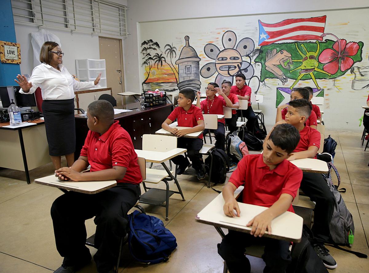 Principal Victoria Garcia Burgos welcomes sixth-grade students on Monday at Rosa Costa Valdivieso middle school in Yabucoa, Puerto Rico. It’s been almost a year since Hurricane Maria hit Puerto Rico as a Category 4 hurricane.