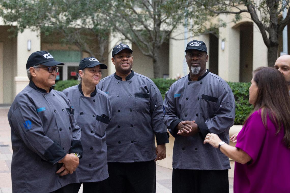 Students in the culinary program at Camillus House listen to Hilda Fernandez, right, CEO, talk after a press conference announcing a $2 million city donation to Camillus House as part of the “Functional Zero” homeless plan on Friday, Oct. 14, 2022, in Miami. Camillus House has programs on its campus in affiliation with Miami Dade College and Florida International University to give courses in construction and culinary arts to people trying to get off the streets.