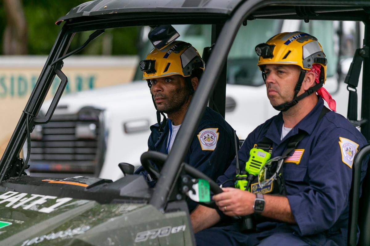 First responders make their way toward the Champlain Towers South condo in Surfside, Florida, on Tuesday, July 6, 2021. The condo tower partially collapsed on June 24, 2021, killing 98 people.