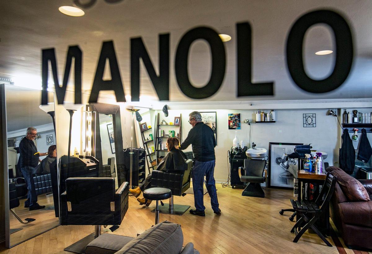 Hairdresser Manolo Portuondo works on customer Tatiana SalernoÕs hair at his hair salon in Coconut Grove on Friday, April 24, 2020.