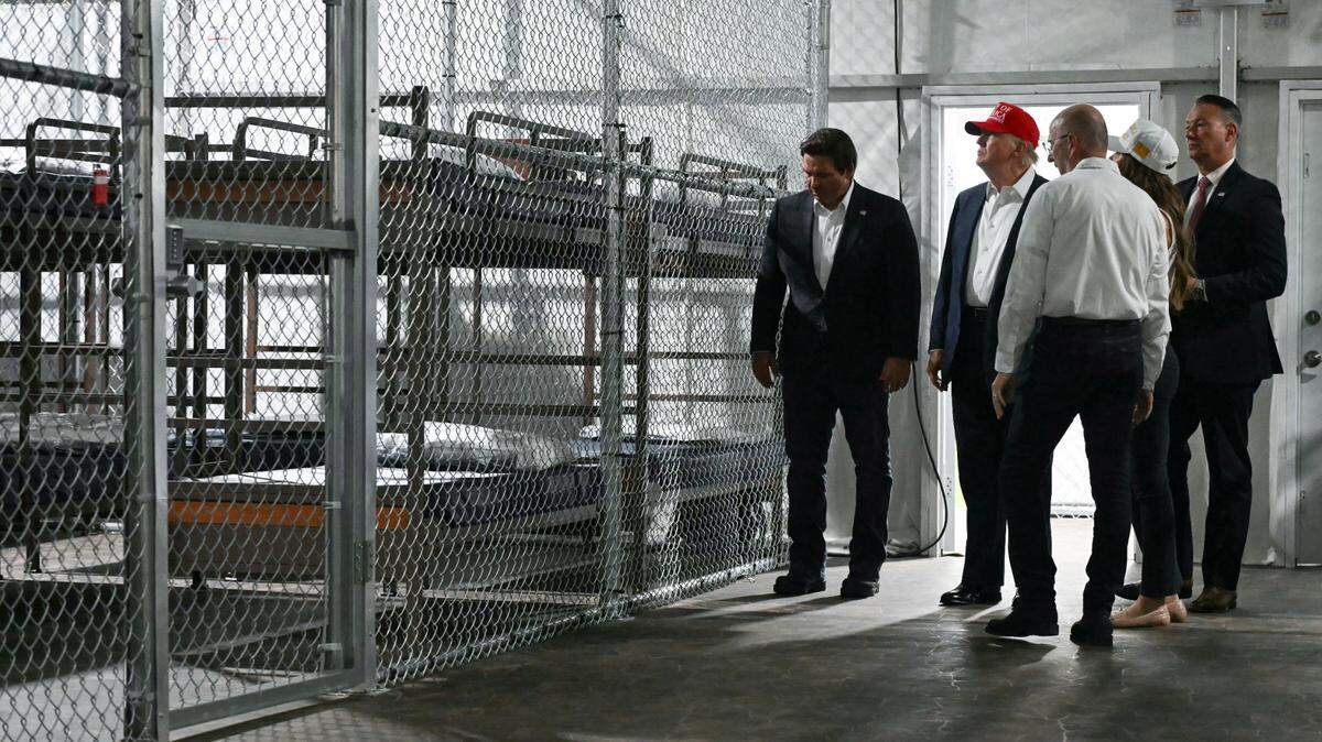 US President President Donald Trump (2L), alongside Florida Governor Ron DeSantis (L), tour the Florda immigrant detention center dubbed “Alligator Alcatraz.”
