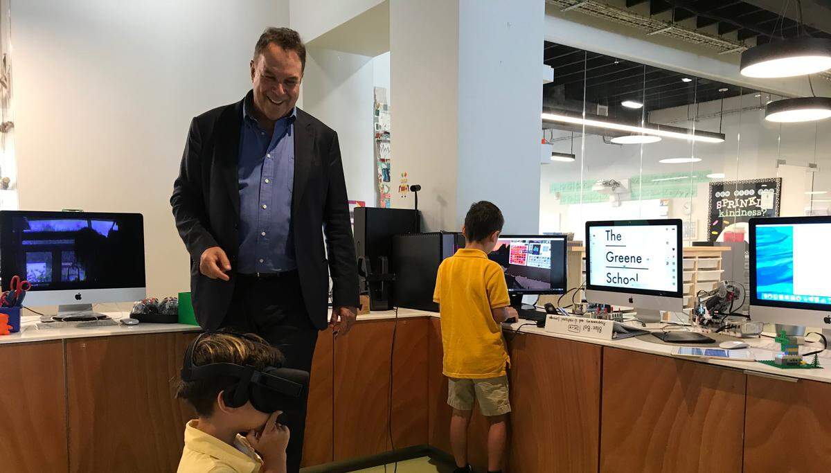 Jeff Greene’s sons Cameron, 4, and Brandon, 6, show off the virtual-reality gadgets at The Greene School on Aug. 13. Through the technology, they can virtually visit locations across the globe via Google Earth.  Greene, a Democratic candidate for governor, opened the school with his wife in 2016.