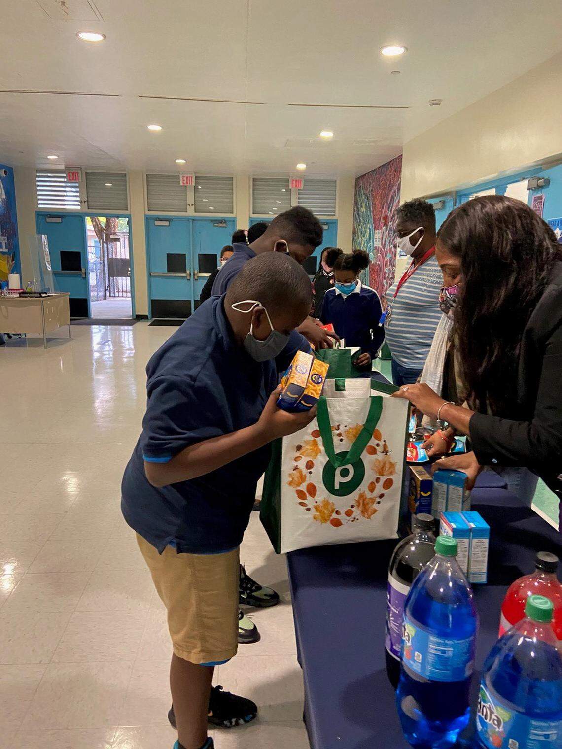 Students in the South Florida After-School All-Stars program get to work packing Thanksgiving food to donate to the needy.