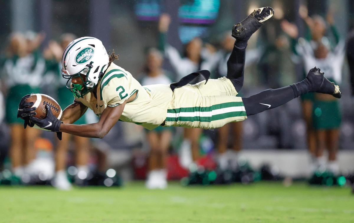 Miami Central’s Corey Washington (2) dives into the end zone to score the second quarter against American Heritage during the 2022 FHSAA State Championships-Class 2M at DRV PNK Stadium in Ft. Lauderdale on Friday, December 16, 2022.