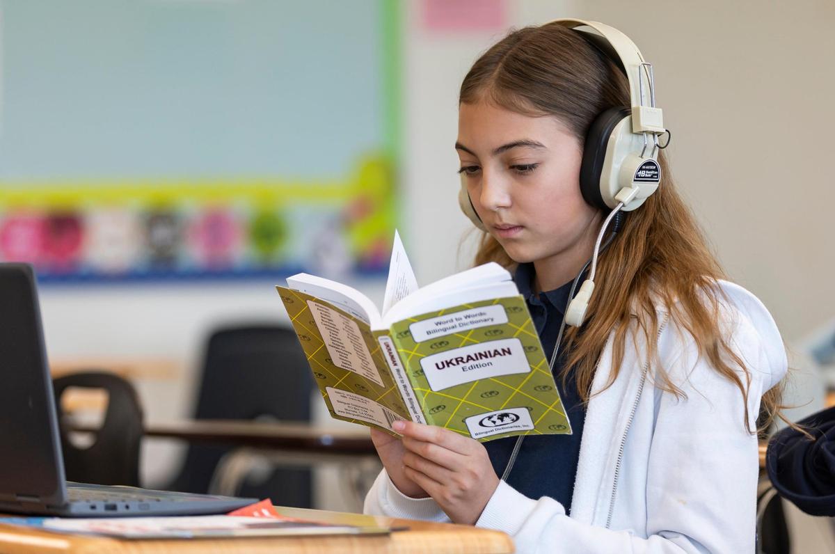 Maria Sakhnenko, 12, from Ukraine, uses a Ukrainian word-to-word bilingual dictionary in his ESOL class at Aventura Waterways K8 Center.