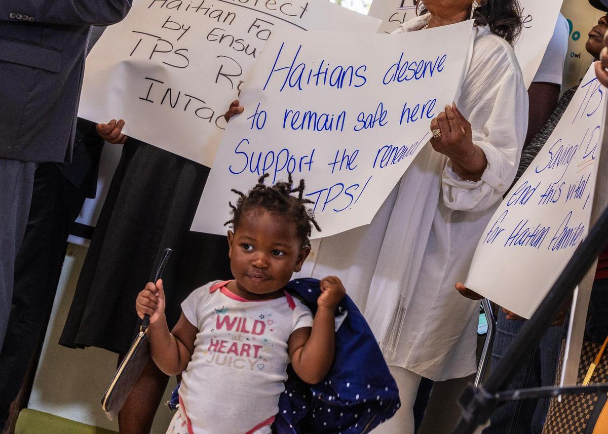Jenny Bellus, 22, months old, reacts as she attends with her mother Rose Myrlene Elmond, a TPS holder, during a press conference called by the Family Action Network Movement to discuss the roll back of Haiti TPS by President Trump administration affecting thousand of Haitian Families, on Friday, February 21, 2025.