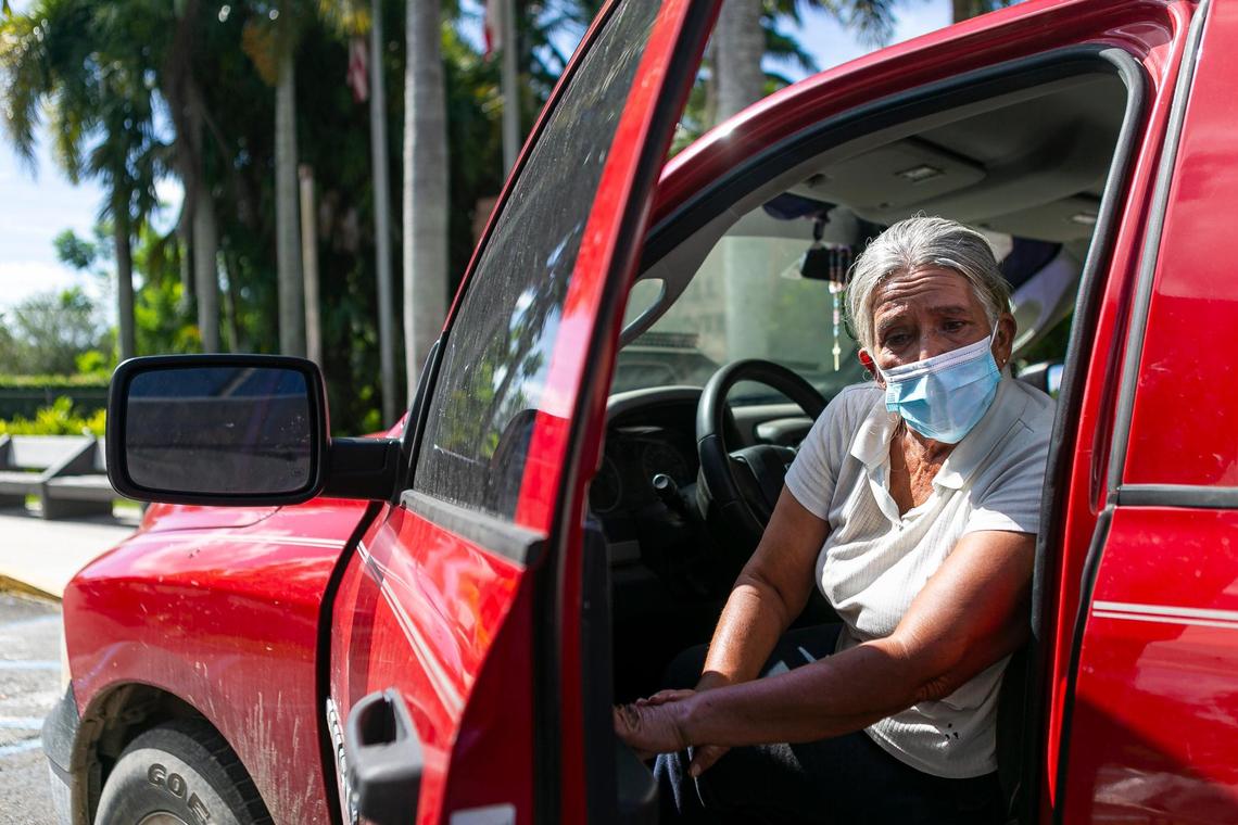 Elvira Cepeda, 61, an employee at JFR Harvesting, waits at a drive-thru to receive a bag with reusable and washable face masks alongside COVID-19 informational packets from the Coalition of Florida Farmworker Organizations at the UF IFAS Extension office in Homestead, Florida on Friday, July 3, 2020.