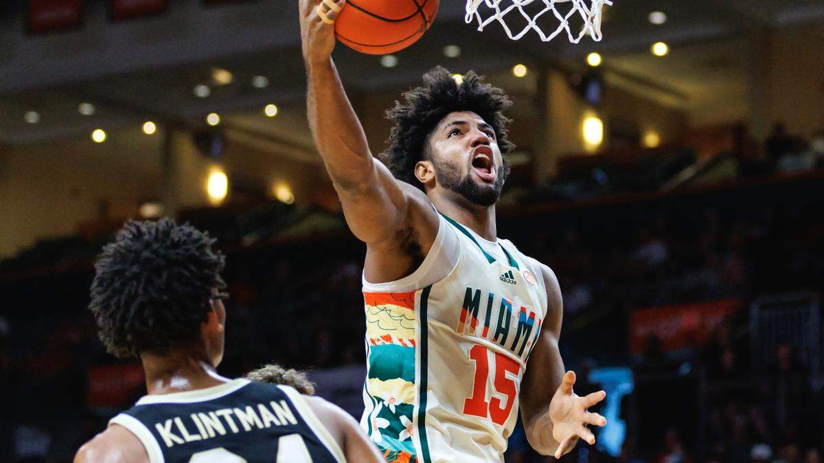 Miami Hurricanes forward Norchad Omier (15) goes to the basket against Wake Forest Demon Deacons forward Bobi Klintman (34) and Demon Deacons forward Matthew Marsh (33) uring the first half of an NCAA college basketball game at Watsco Center on Saturday, February 18, 2023 in Coral Gables, Florida.