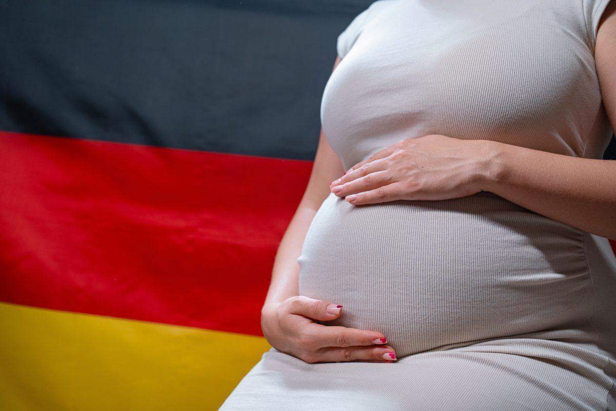 pregnant woman in front of germany flag