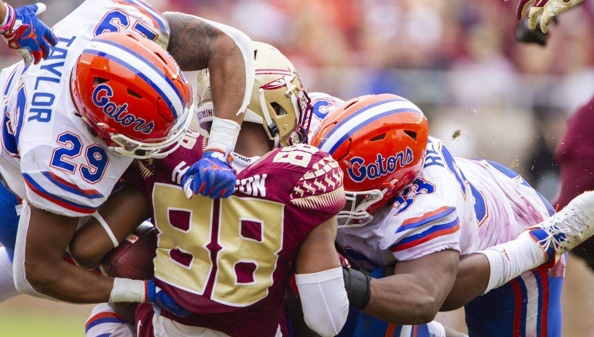 Florida defensive back Jeawon Taylor (29) and linebacker David Reese II (33) stop Florida State wide receiver Tre’Shaun Harrison (88) in the second half of an NCAA college football game in Tallahassee, Fla., Saturday, Nov. 24, 2018. Florida defeated Florida State 41-14.