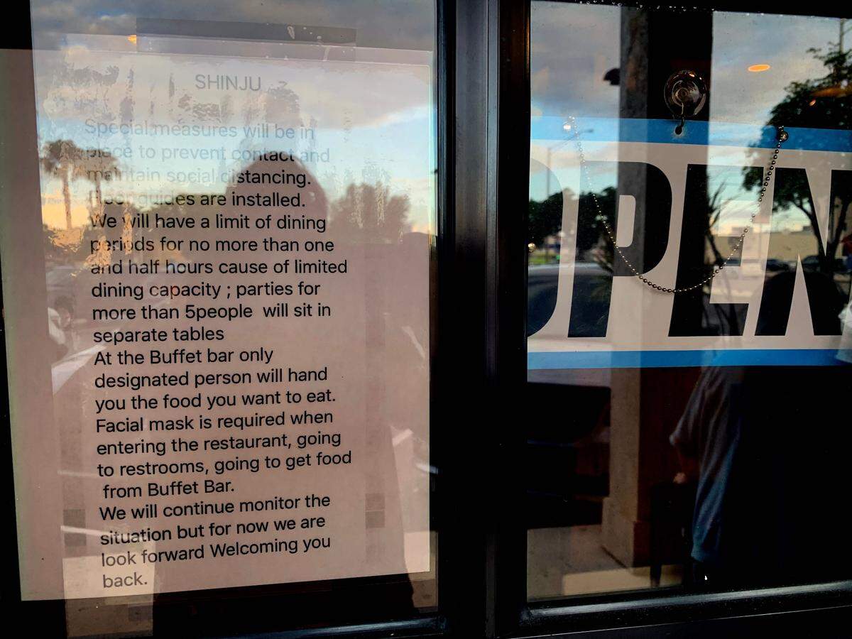 Shinju Japanese Buffet is now open. Signage on the doors of the South Miami location off Sunset Drive and 87th Avenue points out the new protocols during the coronavirus pandemic.