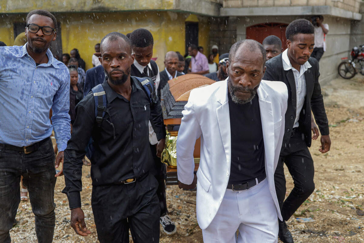 Mourners carry a casket during a funeral service for people killed in an armed gang attack on August 23, in Kenscoff, Haiti, September 2, 2026.