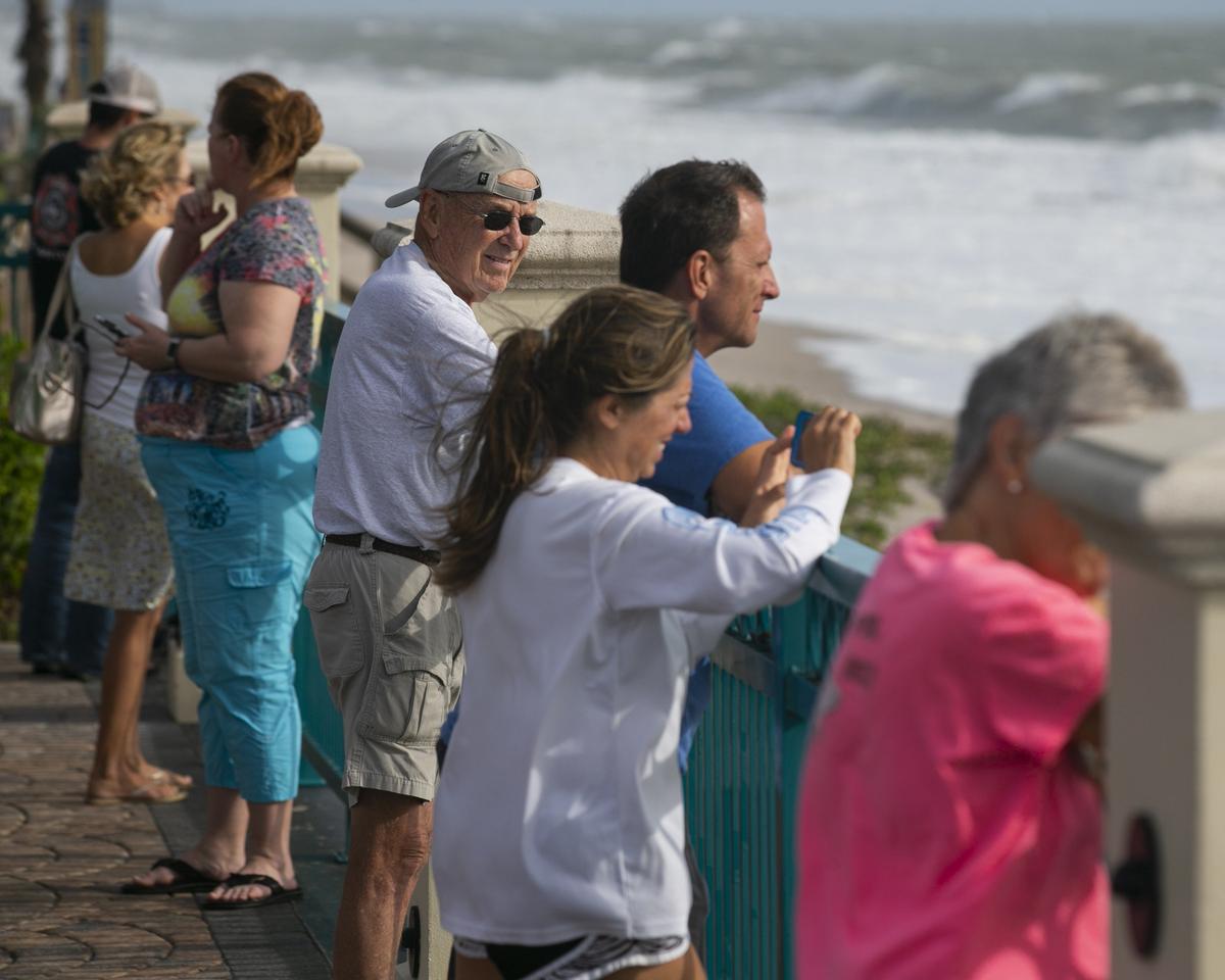 Beachgoers in Sexton Plaza watch the waves crash onto Vero Beach as Hurricane Dorian inches closer to Florida’s Treasure Coast on Monday, Sept. 2, 2019.
