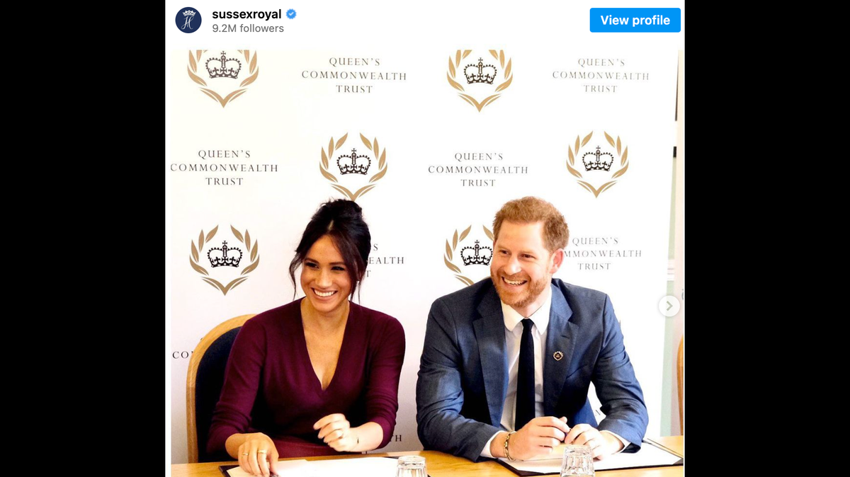 After presenting the trophy to her husband, Prince Harry, he and Meghan Markle shared a public kiss. Then his friend came along.
