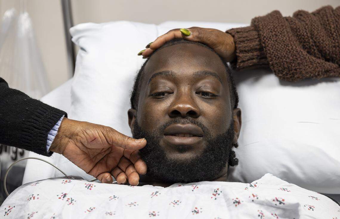 Chevon Byfield, 39, who suffers from heart failure and relies on a left ventricular assist device (LVAD), is consoled by his grandmother, Brylon Brown, left, and his mother, Sharon Brown, before heading to his procedure at Memorial Regional Hospital on Tuesday, Feb. 3, 2026, in Hollywood, Fla. After waiting more than six years for a transplant, Byfield checked into the hospital for the fourth time Tuesday to undergo a quarterly procedure and remain on-site until a compatible heart becomes available.