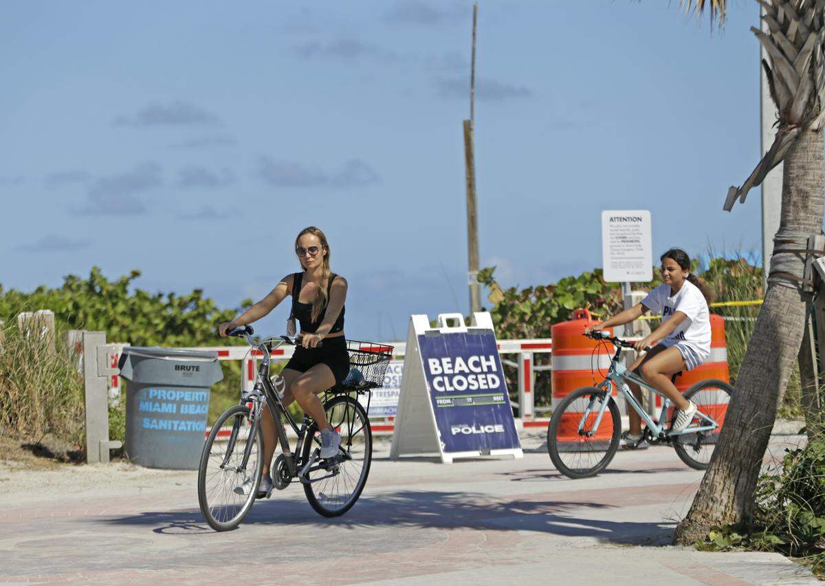 People riding bikes in South Beach after the public beaches were closed in response to the coronavirus pandemic.