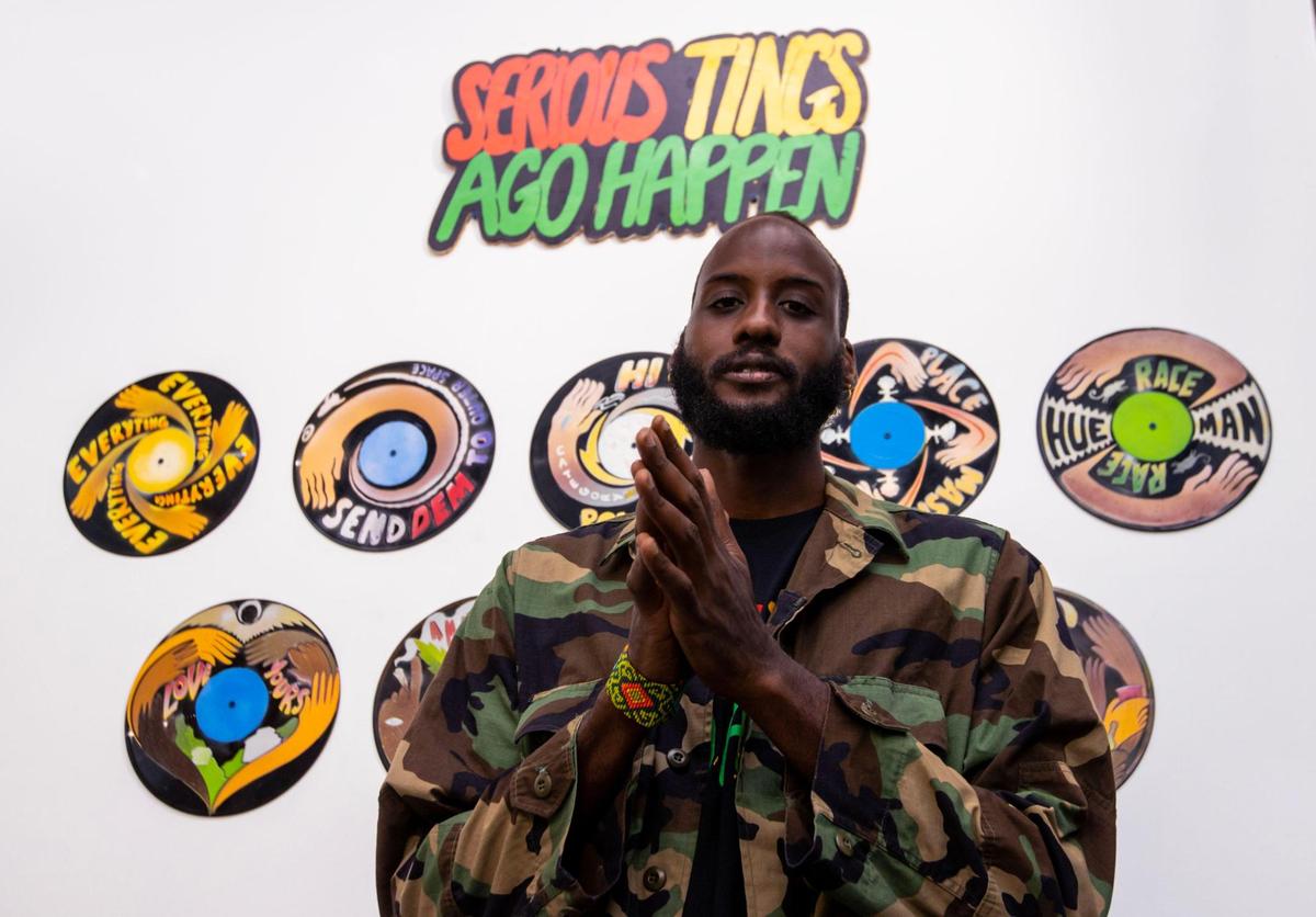 Artist Matthew McCarthy strikes a pose with his installation entitled ‘Serious Tings Ago Happen’ displayed at the Art Prizm Fair. McCarthy created the artwork with collaborator Maxine Walters.