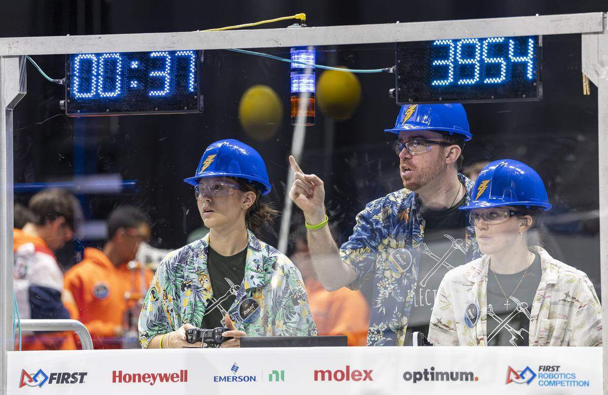 Madilyn Myers, 18, left, and Julia Brooks, 17, both members of Electrotechs, a 4-H team from Western Pennsylvania, drive their robot, Project Digger, as their coach, Alex Caldwell, gives instructions during the 2026 FIRST Robotics South Florida Regional Competition at the University of Miami’s Watsco Center on Friday, April 10, 2026, in Coral Gables, Fla. Participants from local school districts, surrounding states, and international teams are competing for an opportunity to earn a spot at the 2026 FIRST World Championship.