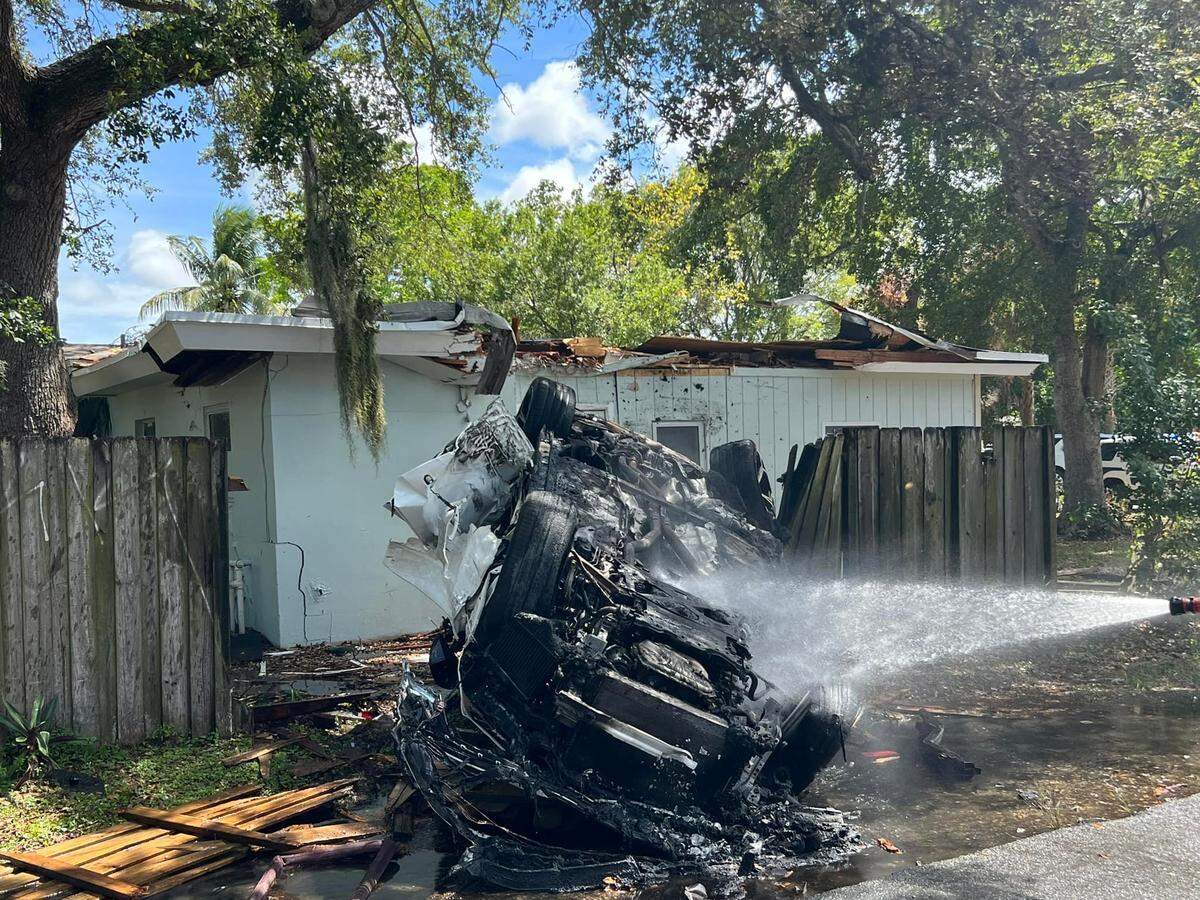 Fort Lauderdale Fire Rescue put out a fire coming from the flipped Lamborghini SUV