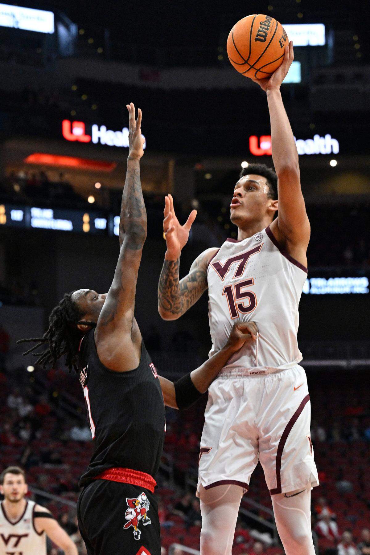 Mar 5, 2024; Louisville, Kentucky, USA; Virginia Tech Hokies center Lynn Kidd (15) shoots against Louisville Cardinals guard Mike James (0) during the first half at KFC Yum! Center. Mandatory Credit: Jamie Rhodes-USA TODAY Sports