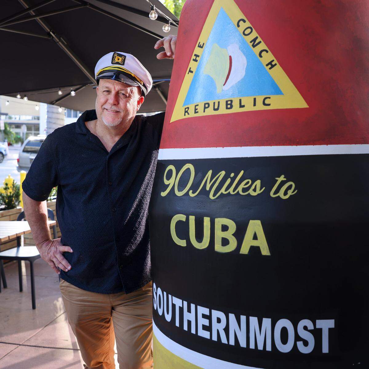 Mario Palazon leans his version of the Key West Southernmost Point buoy at the front door the FreshCo Fish on Wednesday, December 24, 2025 in Doral, Florida.
