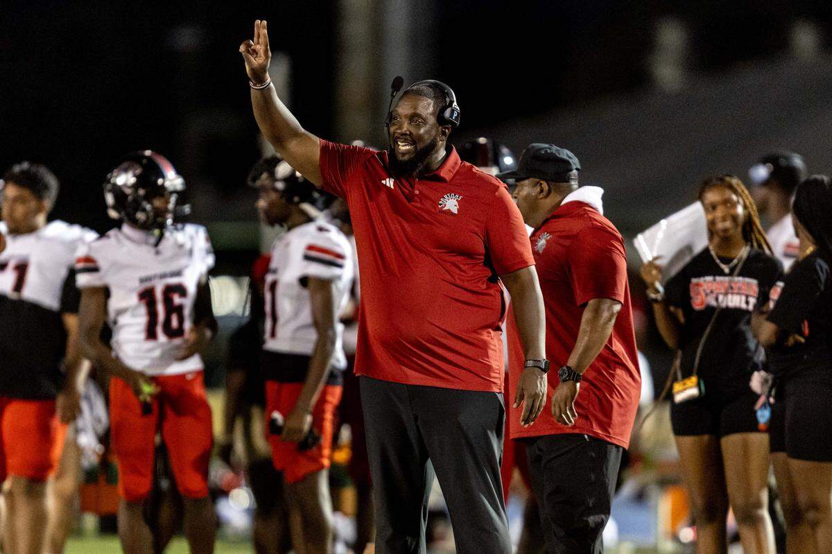 Spartans Head Coach Pierre Senatus speaks to players from the sidelines during the first half of a high school football game between Palmetto and Miami Southridge at Tropical Park on Thursday, September 4, 2025, in Miami, Fla.