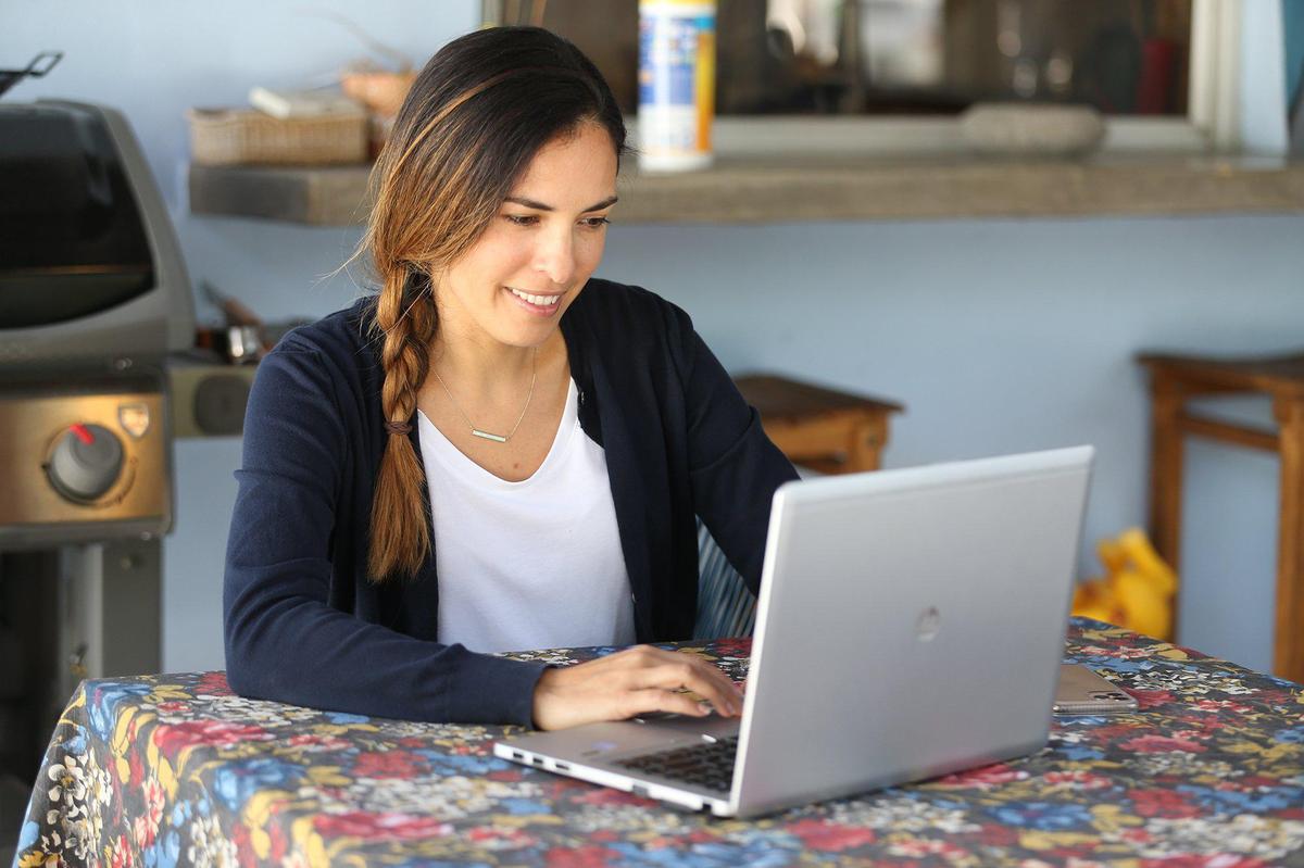 Schoolteacher Maria Paola Attento conducts her first-grade class through Zoom, on Thursday, May 7. She teaches at Aventura Charter School and also has three children at home that she is helping in their studies.