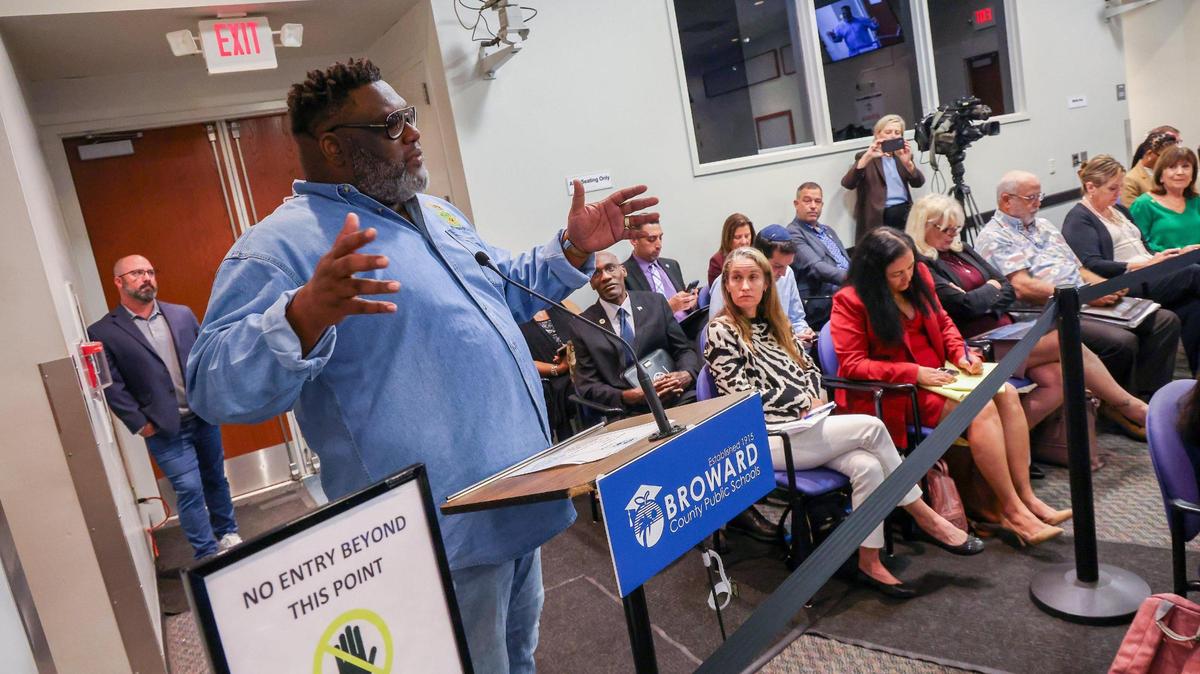 Vicente Thrower, left, gives his remarks against the closing of any schools in Pompano Beach at a meeting with the Broward County Public Schools school board, superintendent, local stakeholders, and members of the community to discuss school closures.