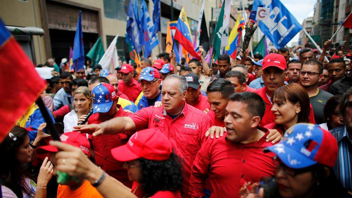 Diosdado Cabello, a member of the Constitutional Assembly and Venezuelan ruling party chief, center front, is surrounded by bodyguard and supporters during an anti-imperialist march to denounce Trump’s talk of a “military option” for resolving the country’s political crisis in Caracas, Venezuela, Monday, Aug. 14, 2017.